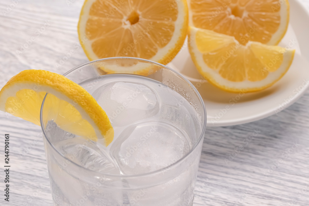 Refreshing cold water with lemon. With ice. Ready to eat. Next is a knife after cutting fruit. Misted glass. Refreshing cold water with lemon. With ice. Ready to eat. Next is a knife after cutting fruit. Misted glass.