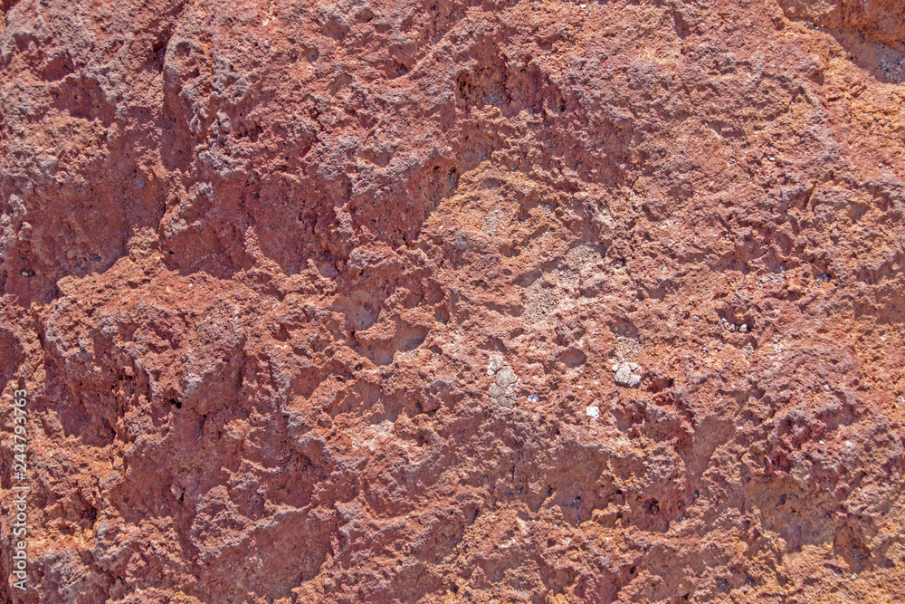 Textured red stone rough surface, rocky background, structure