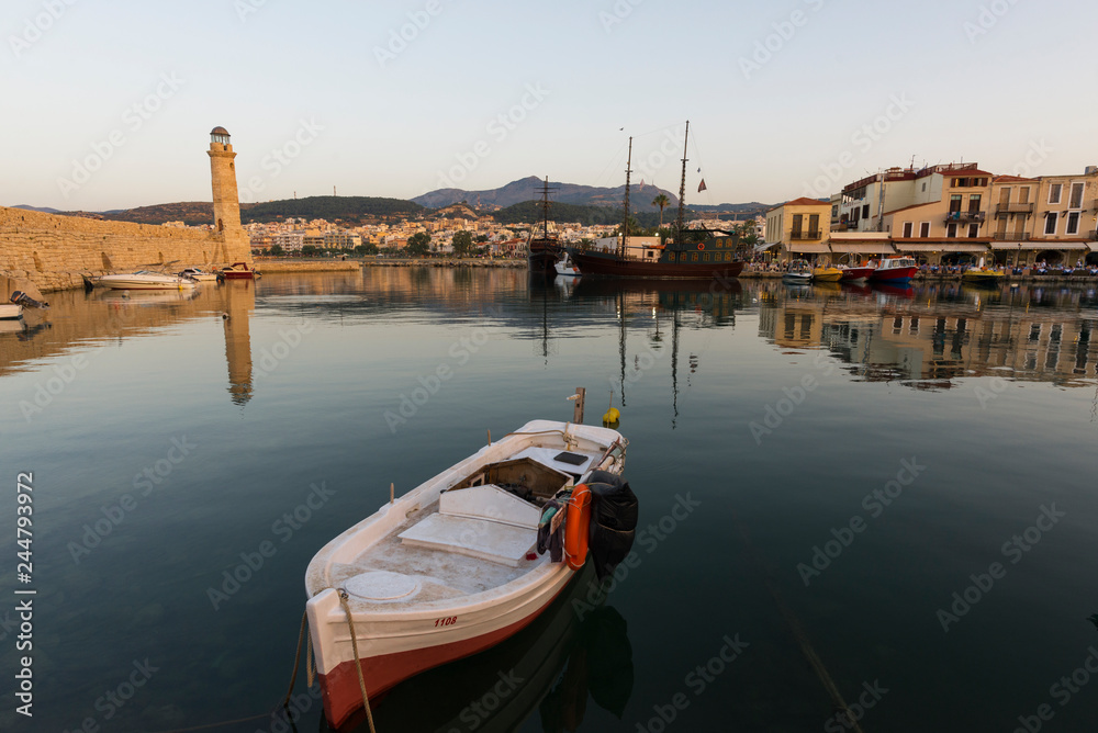 Fototapeta premium Greece, Crete Rethymnon, old venetian harbor, beautiful boats at the sunset..