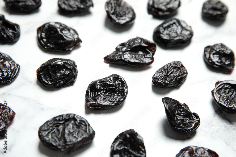 Dried plums on marble background. Healthy fruit Dried plums on marble background. Healthy fruit