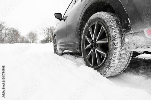 Snowy country road with car on winter day, closeup. Space for text © New Africa