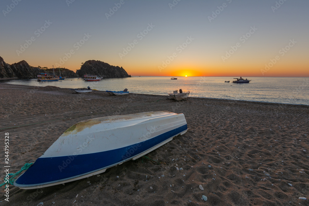 Sunrise on the Mediterranean coast, against the background of fishing boats. Sunrise on the Mediterranean coast, against the background of fishing boats.