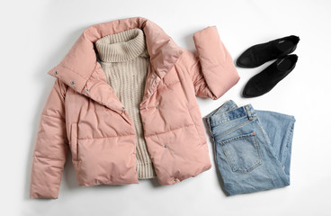 Flat lay composition with female winter clothes on white background