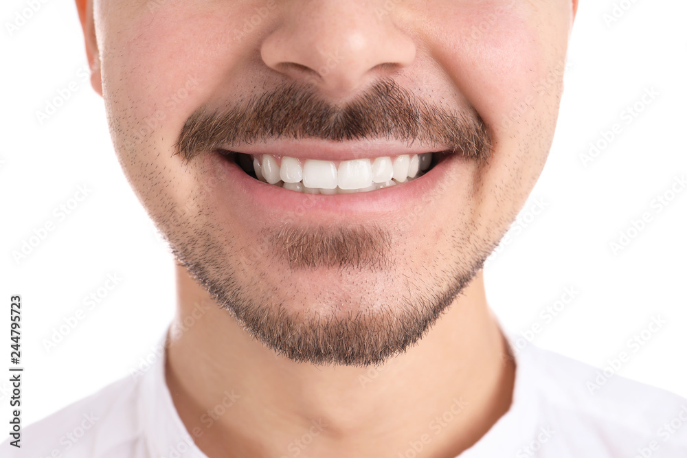 Young man with healthy teeth smiling on white background, closeup Young man with healthy teeth smiling on white background, closeup