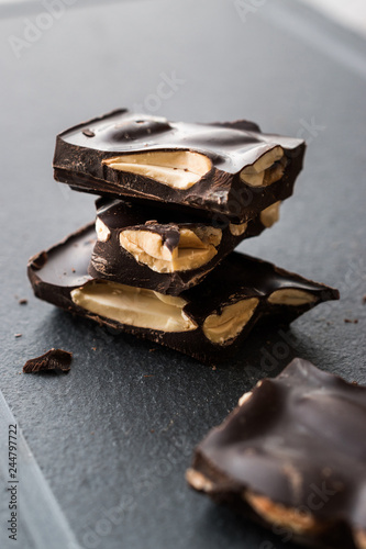 Bitter Almond Chocolate Pieces Dark Marble Surface.