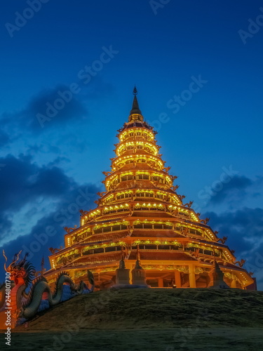 Beautiful Pagoda chinest style decorate with lighting at night with cloudy sky background, Wat Huay Pla Kang, Chiang Rai, Thailand