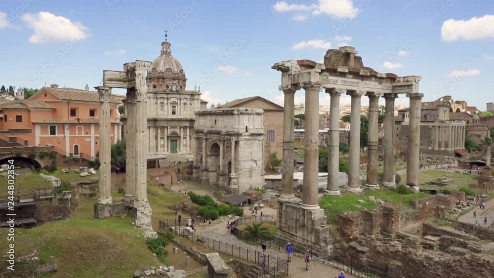 Exterior of ancient ruins Forum Romanum. Unrecognizable people walking through Roman forum in center of Rome, Italy. Historical european architecture. Columns and stones of old monument in slow motion Exterior of ancient ruins Forum Romanum. Unrecognizable people walking through Roman forum in center of Rome, Italy. Historical european architecture. Columns and stones of old monument in slow motion