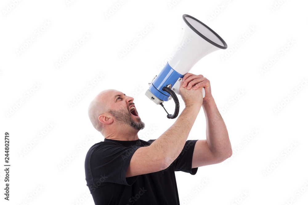 Portrait of angry man shouting with a megaphone. Bearded man yelling into a megaphone. Portrait of angry man shouting with a megaphone. Bearded man yelling into a megaphone.