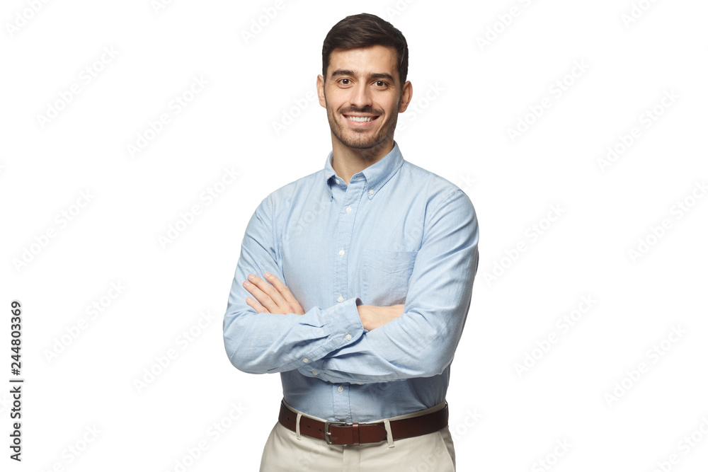 Handsome smiling business man in blue shirt standing with crossed arms, isolated on white background - obrazy, fototapety, plakaty 