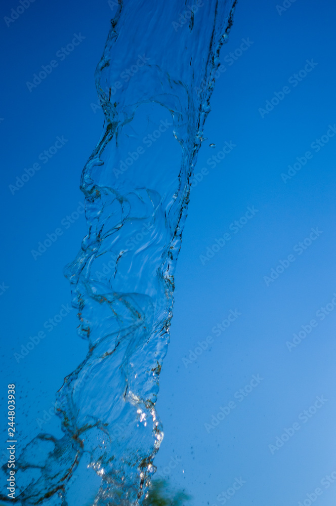 transparent falling water vertical flows, close up