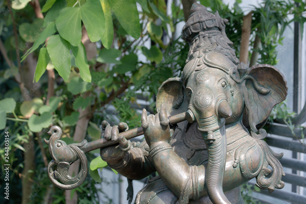 Ganesha playing musical instrument.