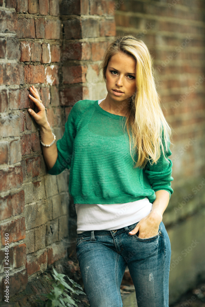 Attractive blond girl posing in the park