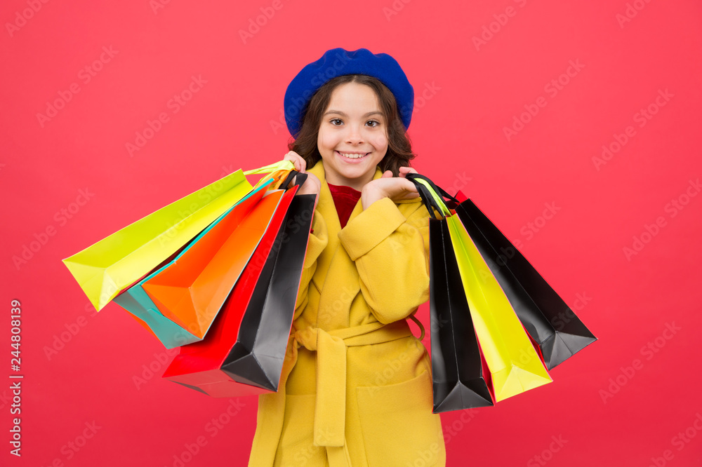 Get discount shopping on birthday holiday. Fashionista adore shopping. Obsessed with shopping. Get major wardrobe refresh with spring sales at stores. Girl cute kid hold shopping bags red background