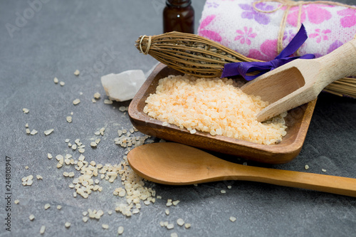 Spa background, bath salt with a wooden scoop. photo