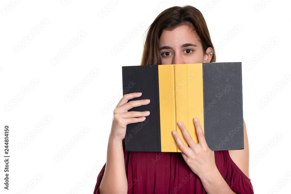 Pretty teenage girl hides her face behind a book Pretty teenage girl hides her face behind a book
