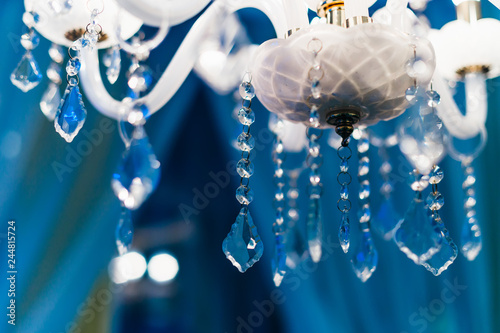 close-up of the bottom of the lamp. transparent beads of different shapes on a blue background