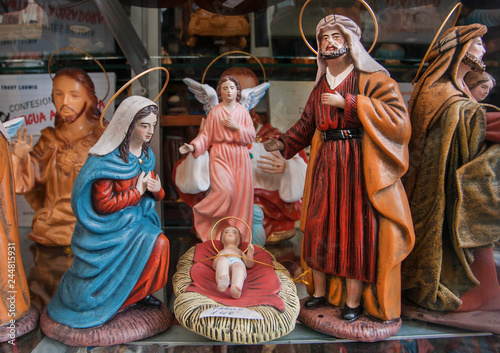 Shop showcase with figurines of baby Jesus, Mary and Joseph, for cozy family home