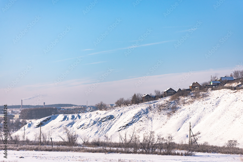 Ural village on the river bank. Steep bank. Private houses in the Russian Outback. Ural village on the river bank. Steep bank. Private houses in the Russian Outback.