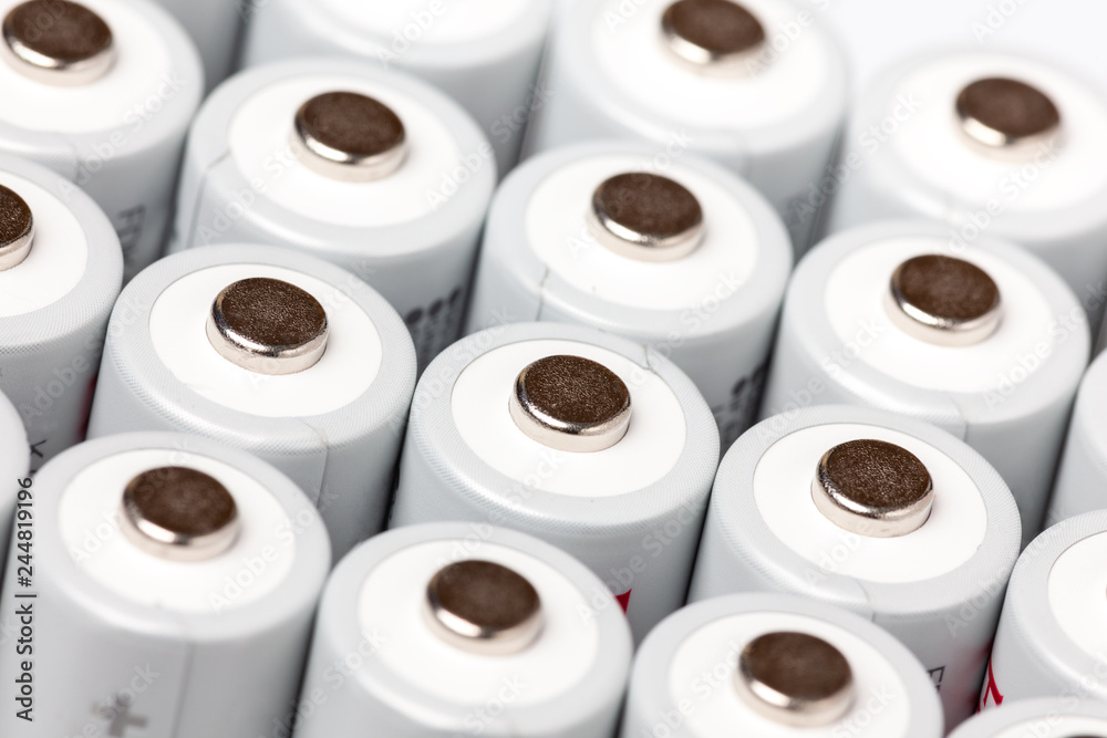 AA batteries are close to each other. Close-up of white batteries on a white background. Battery technology AA batteries are close to each other. Close-up of white batteries on a white background. Battery technology