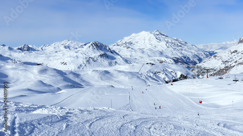 Downhill skiing, snowboarding slopes, off piste trails, in French winter resort of Val d’Isere, Alps , with panorama of mountain snowy peaks and valleys .