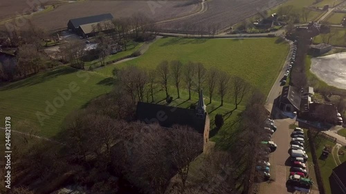 Aerial drone shot from the Andreas Church located on a mound in the center of Westeremden, The Netherlands. photo