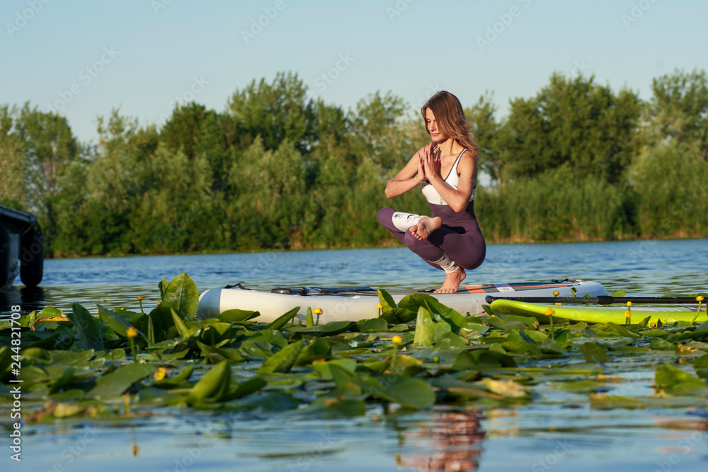 SUP young beautiful girl yoga meditation SUP young beautiful girl yoga meditation