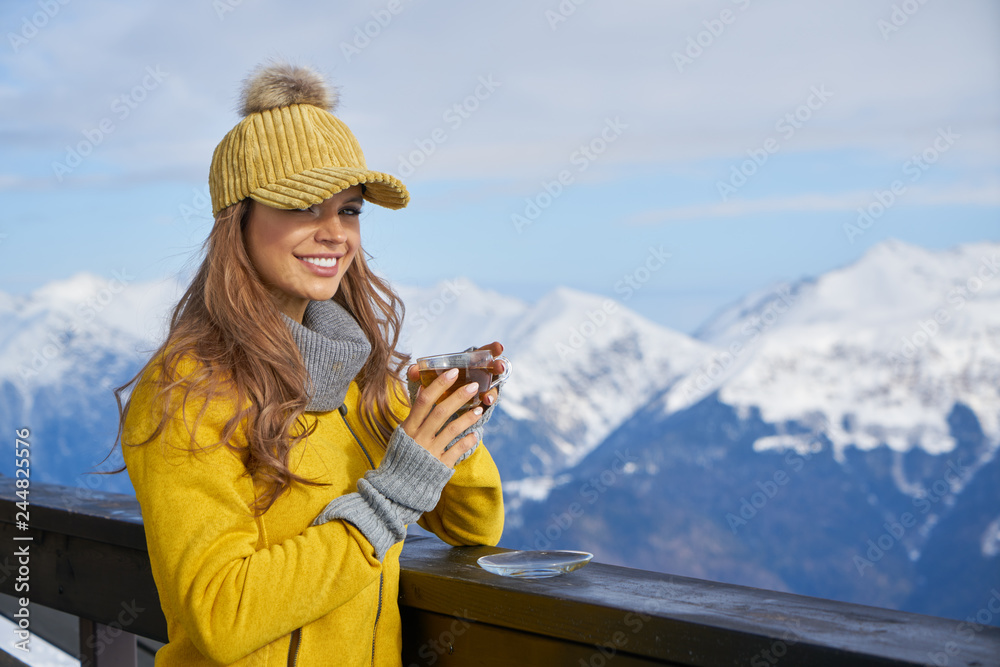 Woman resting after a winter sports on the terrace of the hous. A woman resting after a winter sports on the terrace of the house
