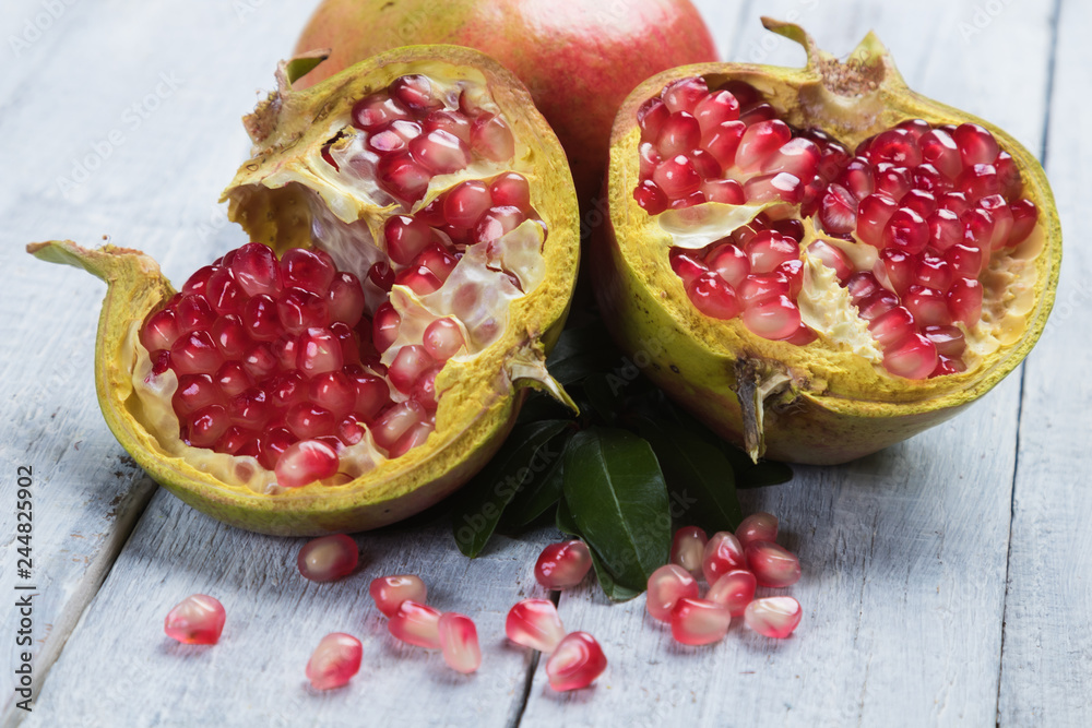 Ripe pomegranate fruit, opened with red seeds Ripe pomegranate fruit, opened with red seeds