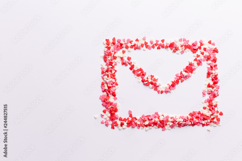 envelope shape on white background made of red white and pink hearts sweets. Top view. Valentine day. love concept. Gift, message for lover. Space for text envelope shape on white background made of red white and pink hearts sweets. Top view. Valentine day. love concept. Gift, message for lover. Space for text