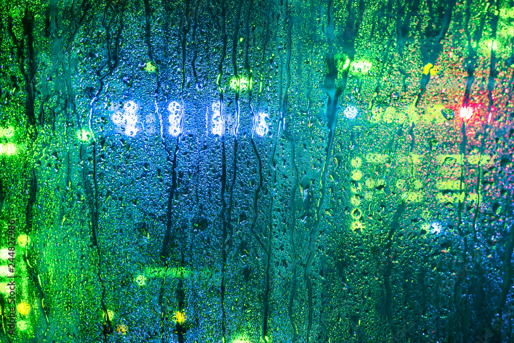 Drops on the glass wall of the server room. Moisture and water in the computer data center. Abstract background