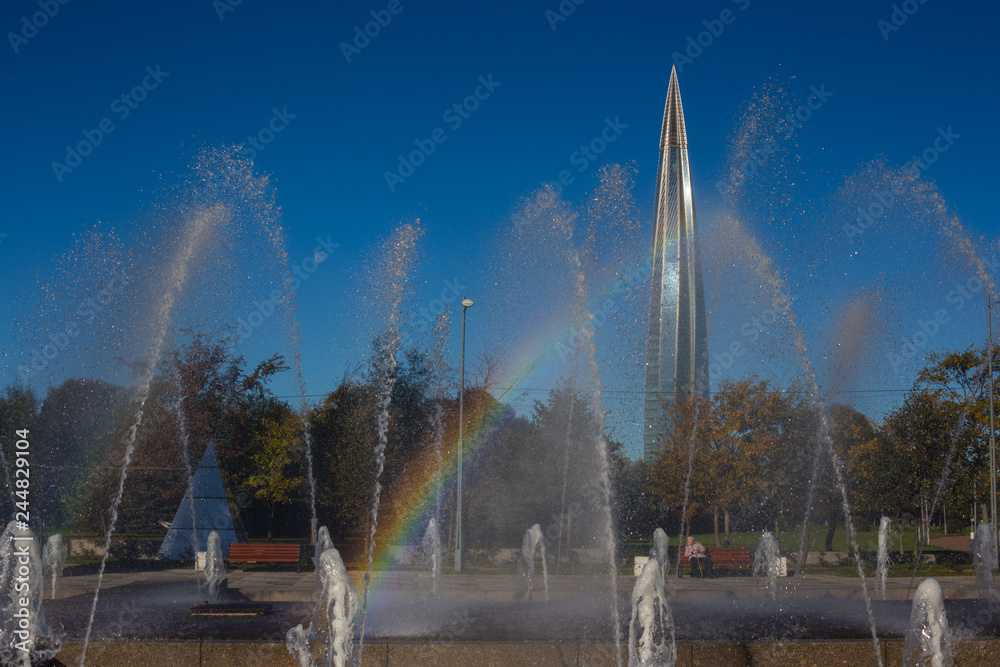 Fototapeta premium modern high skyscraper view from the park day, sun with rainbow