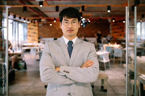 Successful businessman standing at coffee shop door