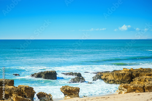 Rocks in blue ocean in sunny day