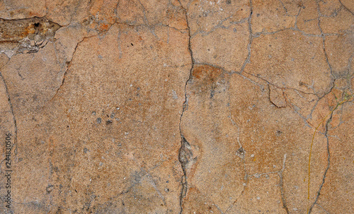 Old plaster with cracks, scratches and damage to concrete. Texture and background cement plaster.