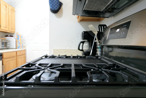 Modern stainless steel gas stove oven in a home.