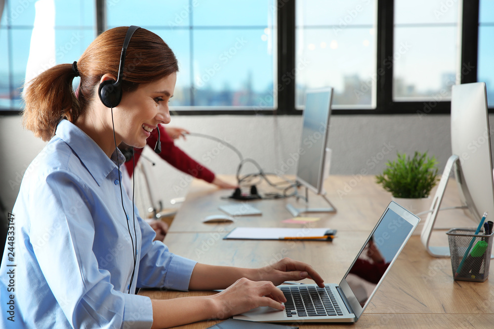 Technical support operator with headset at workplace Technical support operator with headset at workplace