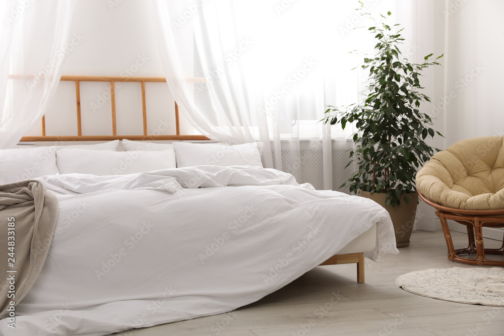 Fototapeta premium Light modern room interior with comfortable bed