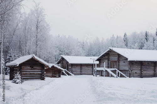 Old wooden houses with barns in North Russia © Vic