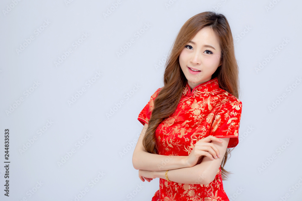 Beautiful portrait happy Chinese New Year young asian woman wear cheongsam smile with gesture congratulation and greeting isolated on white background, festival and celebrate concept. Beautiful portrait happy Chinese New Year young asian woman wear cheongsam smile with gesture congratulation and greeting isolated on white background, festival and celebrate concept.
