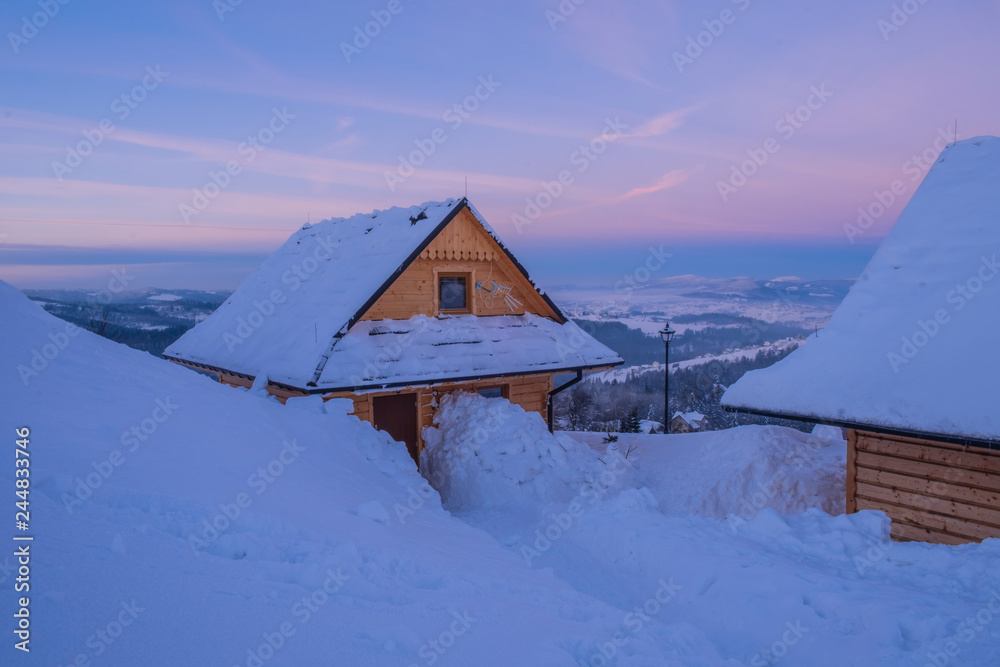 The snow covered wooden village. 