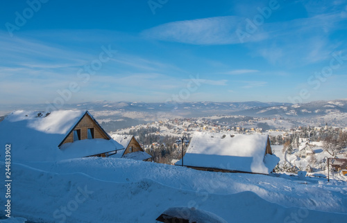 The snow covered wooden village. 