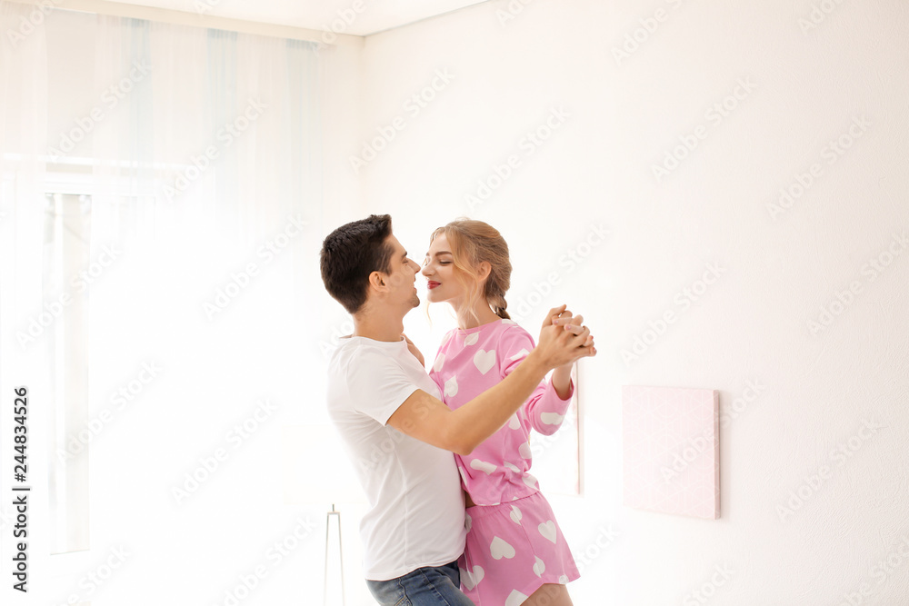Cute young couple dancing indoors Cute young couple dancing indoors