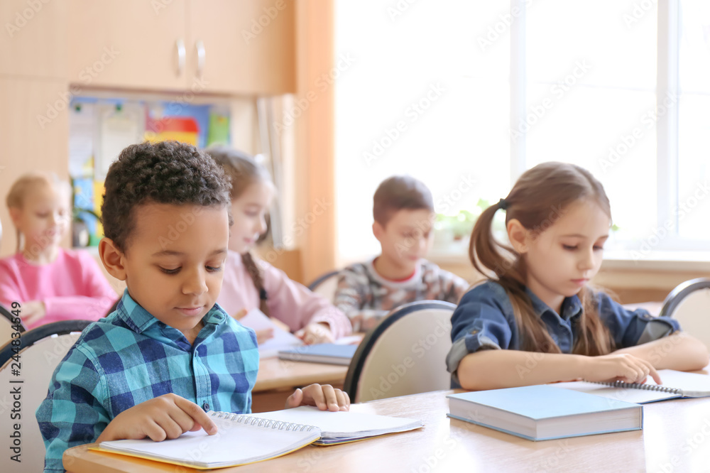 Cute children doing homework in classroom at school Cute children doing homework in classroom at school