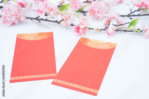 chinese new year celebration with angpao red and plum flowers photo