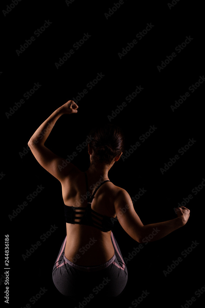beautiful caucasian girl posing, side lit against black background beautiful caucasian girl posing, side lit against black background