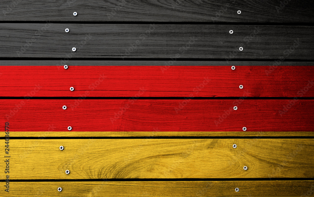 Fototapeta premium German flag painted on old wood plank background. National flag of Germany.