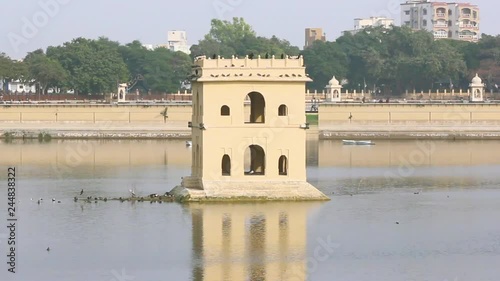 Beautiful little house in middle of lake I ancient minar in lake photo