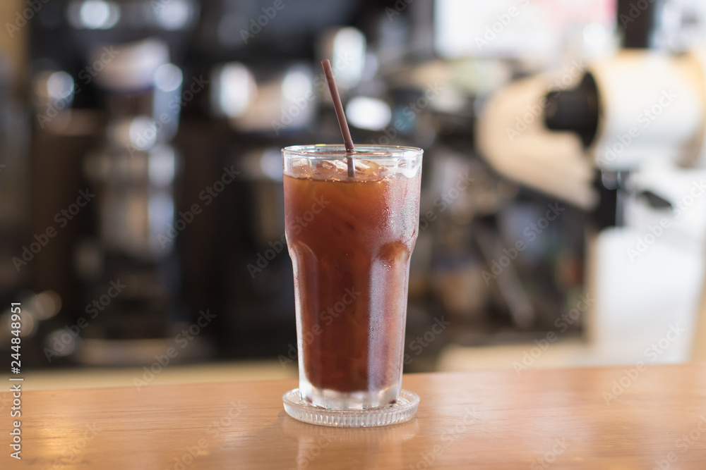Iced Americano coffee.Background with coffee machine and barista. Iced Americano coffee.Background with coffee machine and barista.