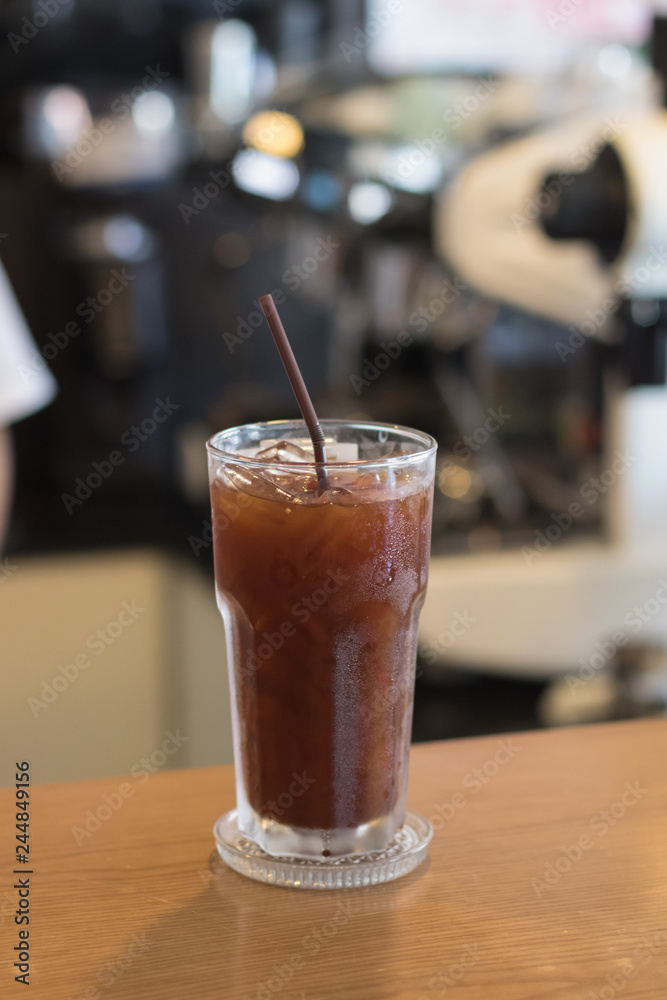 Iced Americano coffee.Background with coffee machine and barista. Iced Americano coffee.Background with coffee machine and barista.