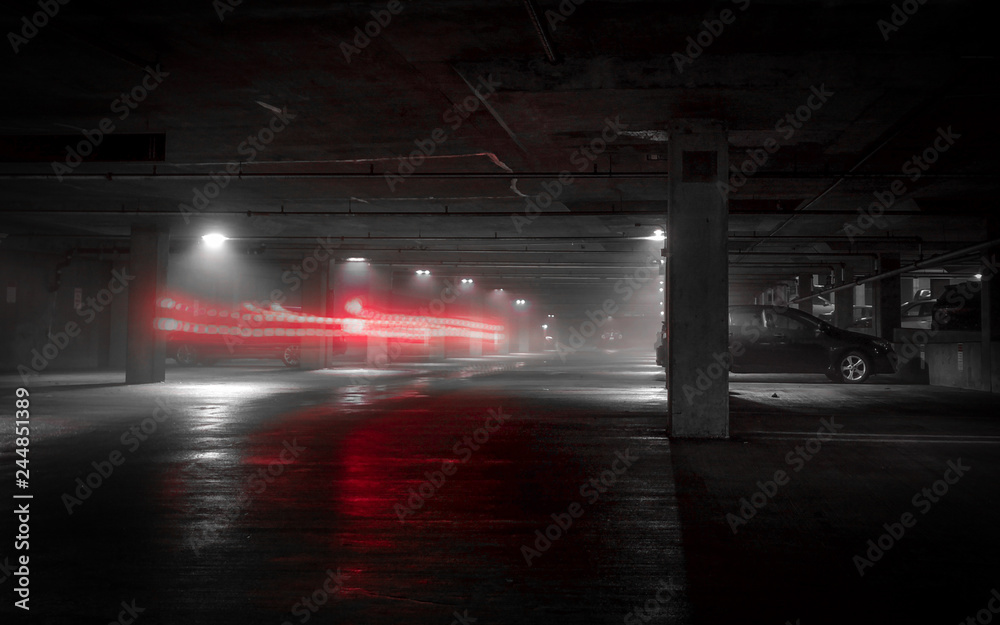 Black, White & Red Colored Long Exposure Photo of Car Lights Driving  Through a Parking Garage on a Foggy, Rainy Night Stock Photo | Adobe Stock
